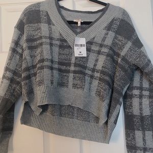 grey plaid v neck sweater.